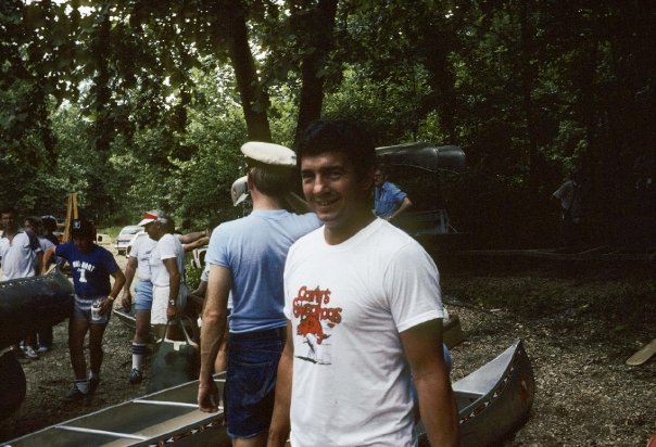Kathryn's father at Walmart Annual Meeting wearing a white t-shirt.